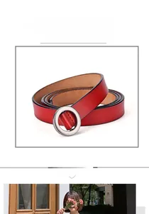 Detail of red leather skinny belt with round alloy buckle and black sealed edges
