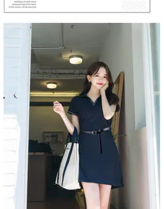 Close-up of a slim black leather belt tied around a short-sleeved black polo dress