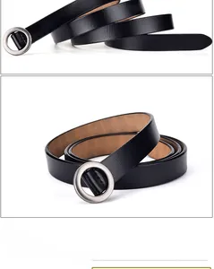Close-up of black matte leather belt coiled with round silver alloy buckle detail