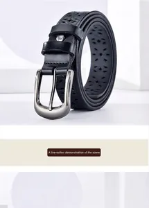 Close-up of black hollow-out floral pattern leather belt with silver brushed metal buckle