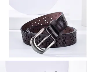 Detail of dark brown leather belt for women featuring laser-cut floral patterns and silver buckle
