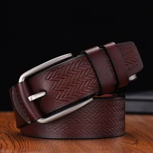 Close-up of dark brown leather belt with diamond woven texture and matte silver pin buckle