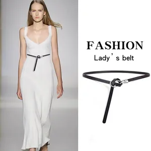Detail of minimalist black leather waist belt with elegant knot-style closure for dresses