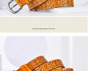 Detailed view of yellow-brown leather belt featuring intricate floral hollow-out carving