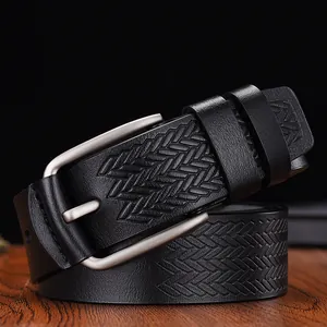 Macro shot of men's black leather belt featuring geometric embossed texture and metal buckle