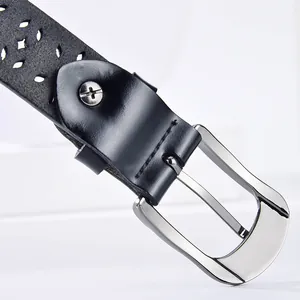 Elegant women's black leather belt featuring hollow-out patterns and a silver pin buckle