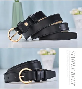 Detail of a women's black leather belt with golden round buckle and fine stitching