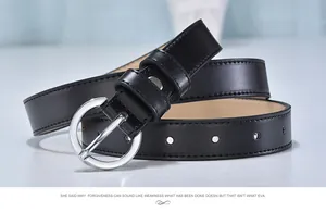 Detail of slim black leather belt featuring a polished silver round metal buckle and stitching