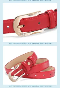 Detail of red leather belt featuring a gold horseshoe buckle with hollow heart and rhinestones