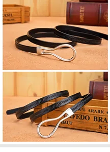 Detail of a slim black leather belt featuring a matte silver oval ring buckle design