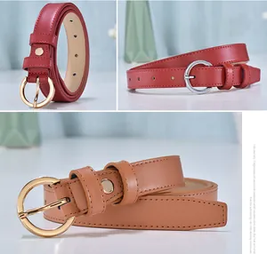 Close-up of leather belts for women showing round metal buckles and fine edge stitching