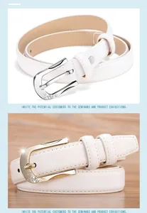 Close-up of horseshoe buckle with heart engraving and rhinestones on white leather belt