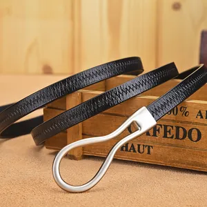 Slim black leather waist belt with silver metal horsebit buckle on rustic wood surface