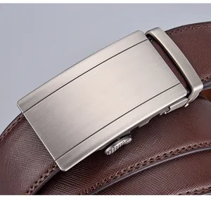 Macro view of brown Saffiano leather belt with brushed metal automatic buckle detail