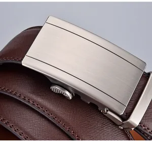 Macro shot of silver automatic buckle and dark brown cross-grain leather belt texture