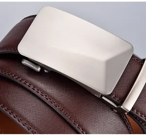Close-up of brown Saffiano leather belt with brushed metal automatic slide buckle