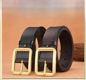 Detailed view of leather belts with gold brushed square metal buckles and pin closure