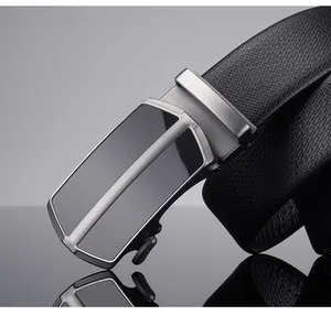 Close-up of black leather belt with brushed alloy automatic buckle and textured finish