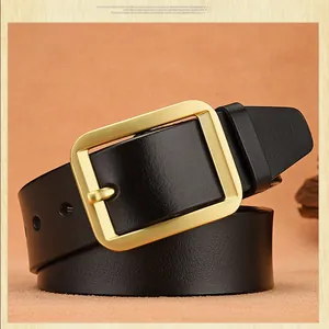 Close-up of a men's black leather belt featuring a matte gold rectangle pin buckle