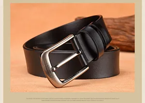 Close-up of matte alloy pin buckle with wire drawing finish on a black cow leather belt