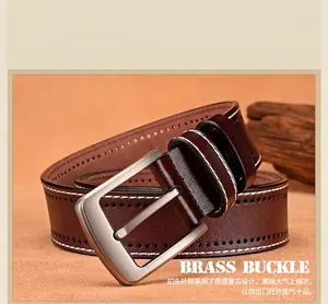Detail of vintage brown leather belt with white stitching and brushed metal buckle