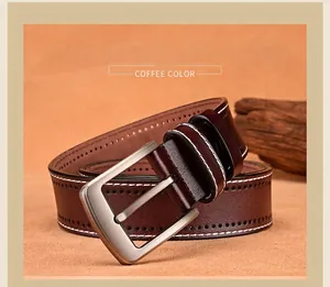 Macro detail of coffee brown leather belt featuring silver needle buckle and contrast stitching