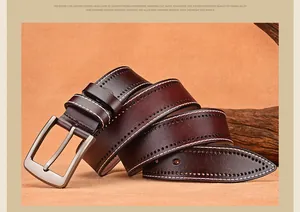 Macro view of brown leather belt showing vintage white stitching and alloy buckle details