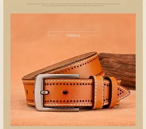 Detail of orange cowhide leather belt with brogue perforations and white contrast stitching