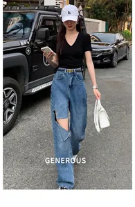 Outdoor street fashion shot of distressed high waist wide leg jeans and black V-neck t-shirt