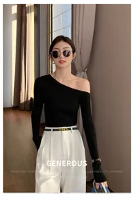 Detail of slim black leather belt paired with high-waist white wide-leg trousers