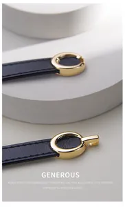 Detailed close-up of a slim black leather belt featuring a polished gold oval buckle