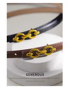 Close-up of black and brown leather thin belts with matte gold interlocking buckles