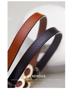 Detail shot of slim leather belts with gold buckles and litchi texture on white display