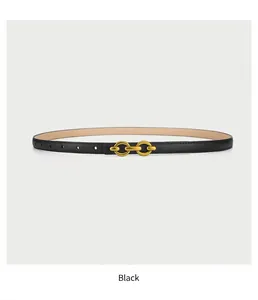 Detail of slim black leather belt featuring a vintage gold-tone double-ring metal buckle