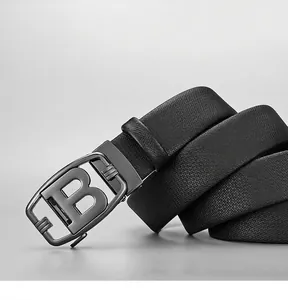 Detail of black leather belt with lychee texture and metallic automatic B buckle