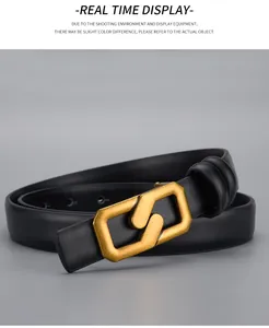 Close-up of black leather belt featuring a polished gold interlocking geometric buckle
