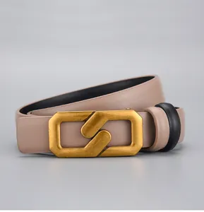 Detailed macro view of beige leather belt with unique matte gold geometric buckle clasp