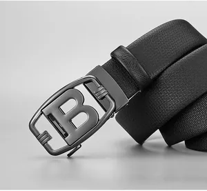 Detail of black pebbled leather belt with a gunmetal letter B automatic buckle