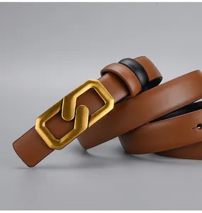 Close-up of brown leather belt with unique interlocking gold geometric buckle and loops