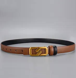 Detail of tan leather belt with vintage gold irregular geometric buckle and round holes