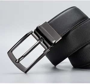 Close-up of black leather belt with diagonal woven texture and gunmetal pin buckle