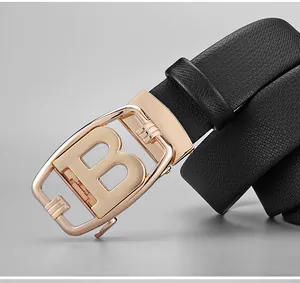 Close-up of black litchi pattern leather belt with golden letter B buckle