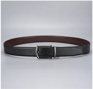 Close-up of black Saffiano leather belt with reversible brown side and gunmetal buckle