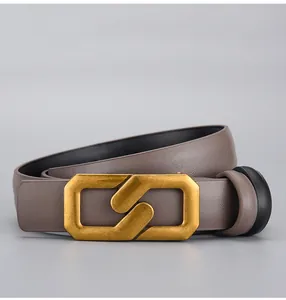 Detail of taupe leather belt with lychee texture and vintage gold S-shaped buckle