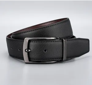 Detail of men's leather belt with twill embossed texture and polished metal pin buckle