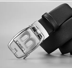Macro detail of men's black leather belt with silver letter B automatic buckle