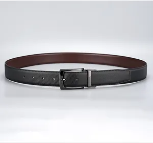 Close-up of reversible dual-color leather belt with gunmetal pin buckle and textured finish