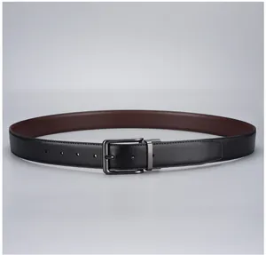 Detail view of double-sided black and brown leather belt with a gunmetal buckle