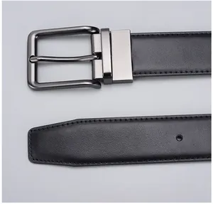 Close-up of gunmetal pin buckle and textured black leather belt for business style