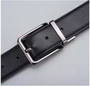 Close-up of black leather belt with gunmetal needle buckle and reinforced stitching
